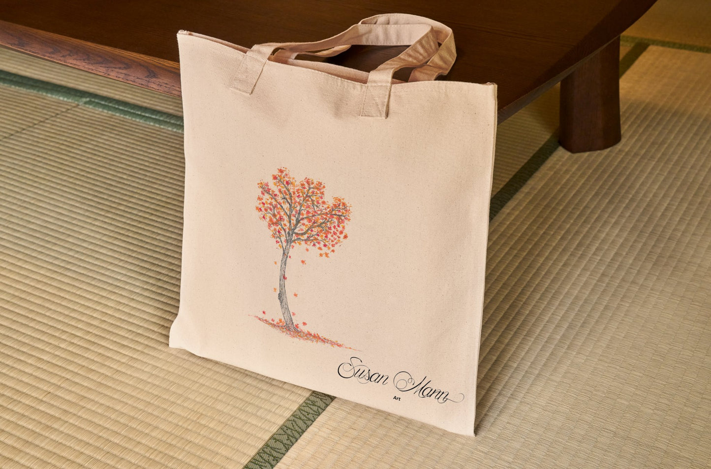 Autumn Tote Bag against a table