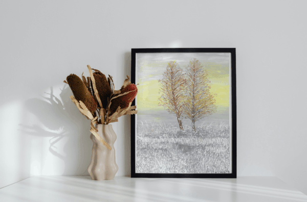 Two bare trees in a snowy field with a gray and yellow sky